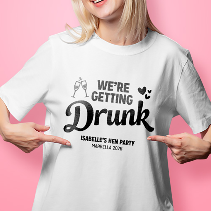 A female model wearing a white t shirt that reads We're getting drunk, Isabelle's Hen Party, Marbella 2026
