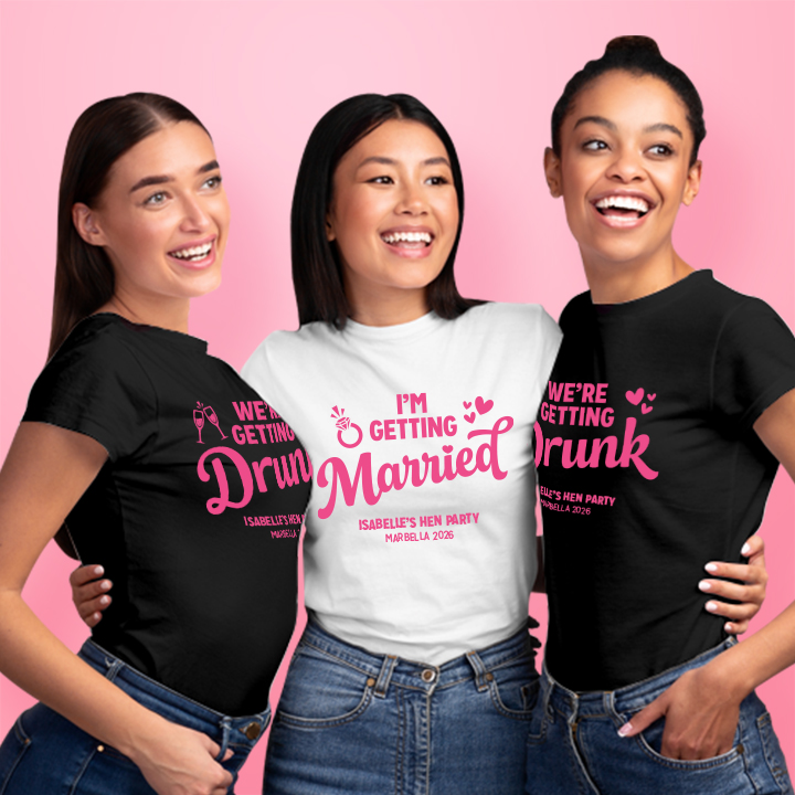 Three female models standing together, the bride is in the middle wearing a white t shirt that reads I'm Getting Married, Isabelle's Hen Party, Marbella 2026 and her two friends are next to her wearing shirts that read we're getting drunk