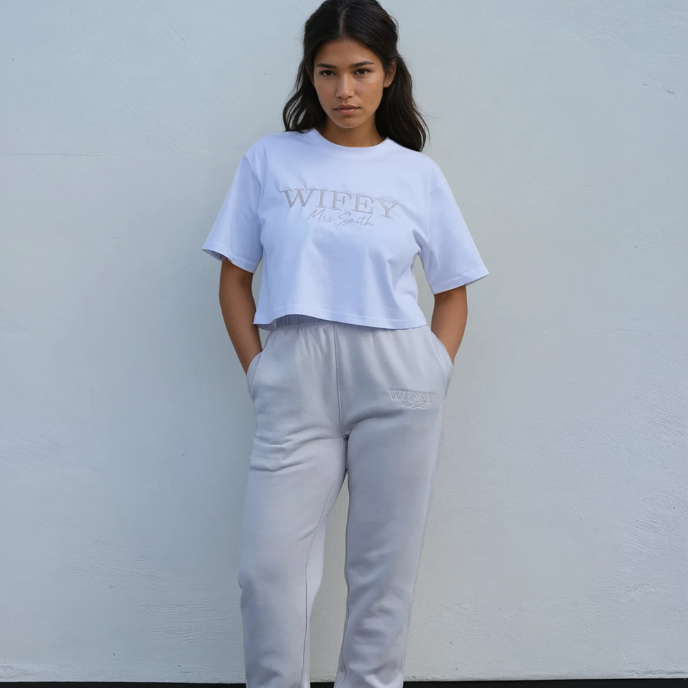 A female model modelling a luxurious bone top that has WIFEY embroidered on it with matching joggers