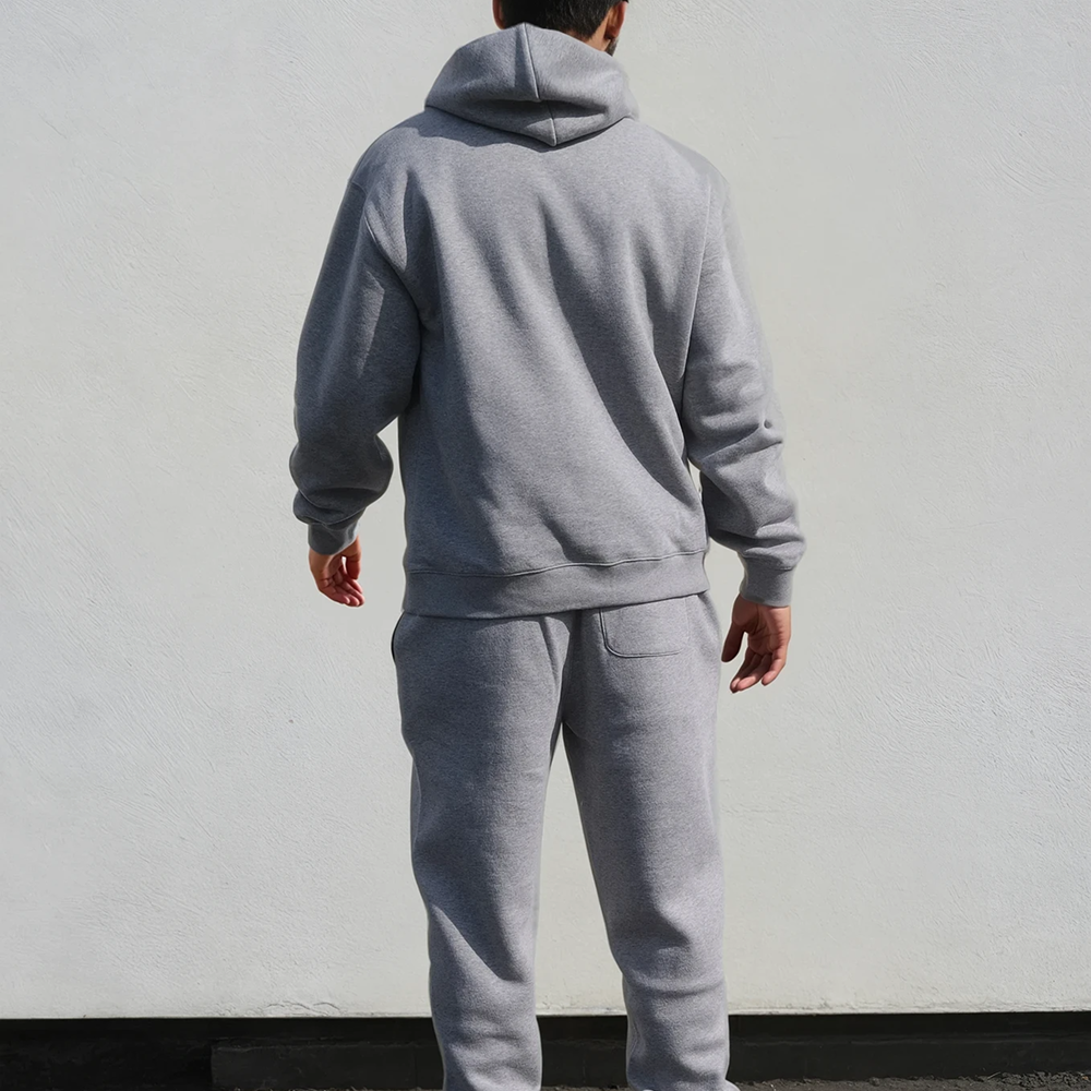 A shot of a male model wearing a luxurious looking hoodie and matching joggers taken from behind