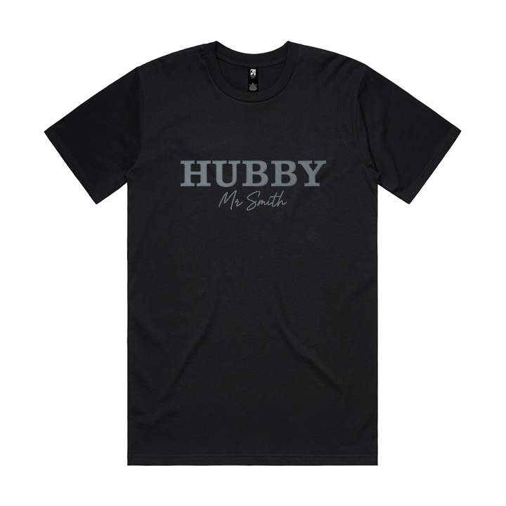 A luxe black honeymoon t shirt with embroidered text that reads HUBBY with Mr Smith underneath it