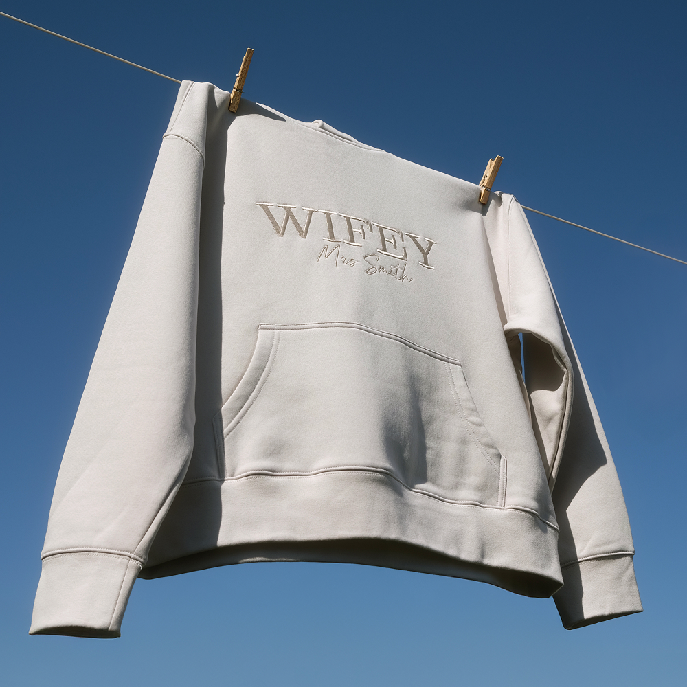 A luxurious looking hoodie with WIFEY in statement text and Mrs Smith in cursive text