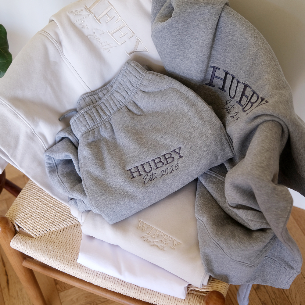 A luxurious matching honeymoonwear his and hers set laid upon a chair