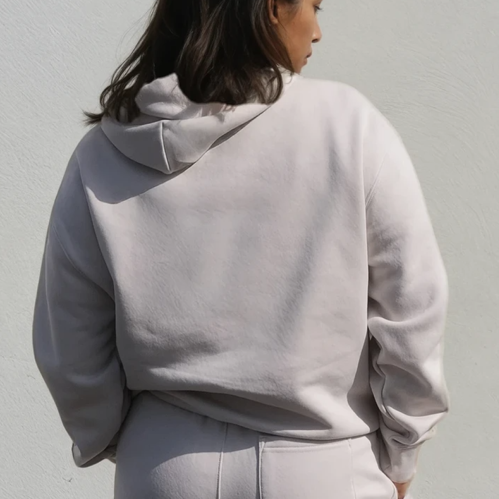 A shot of a model wearing a luxurious looking hoodie and matching joggers taken from behind