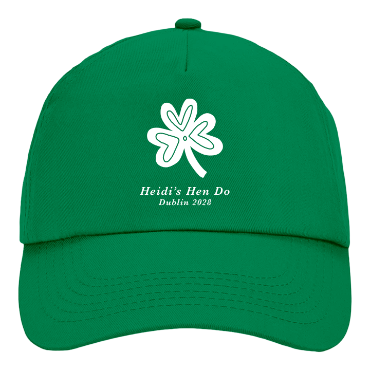 A custom St Paddy's themed hen cap in kelly green with a shamrock design in white with the custom text Heidi's Hen Do Dublin 2028
