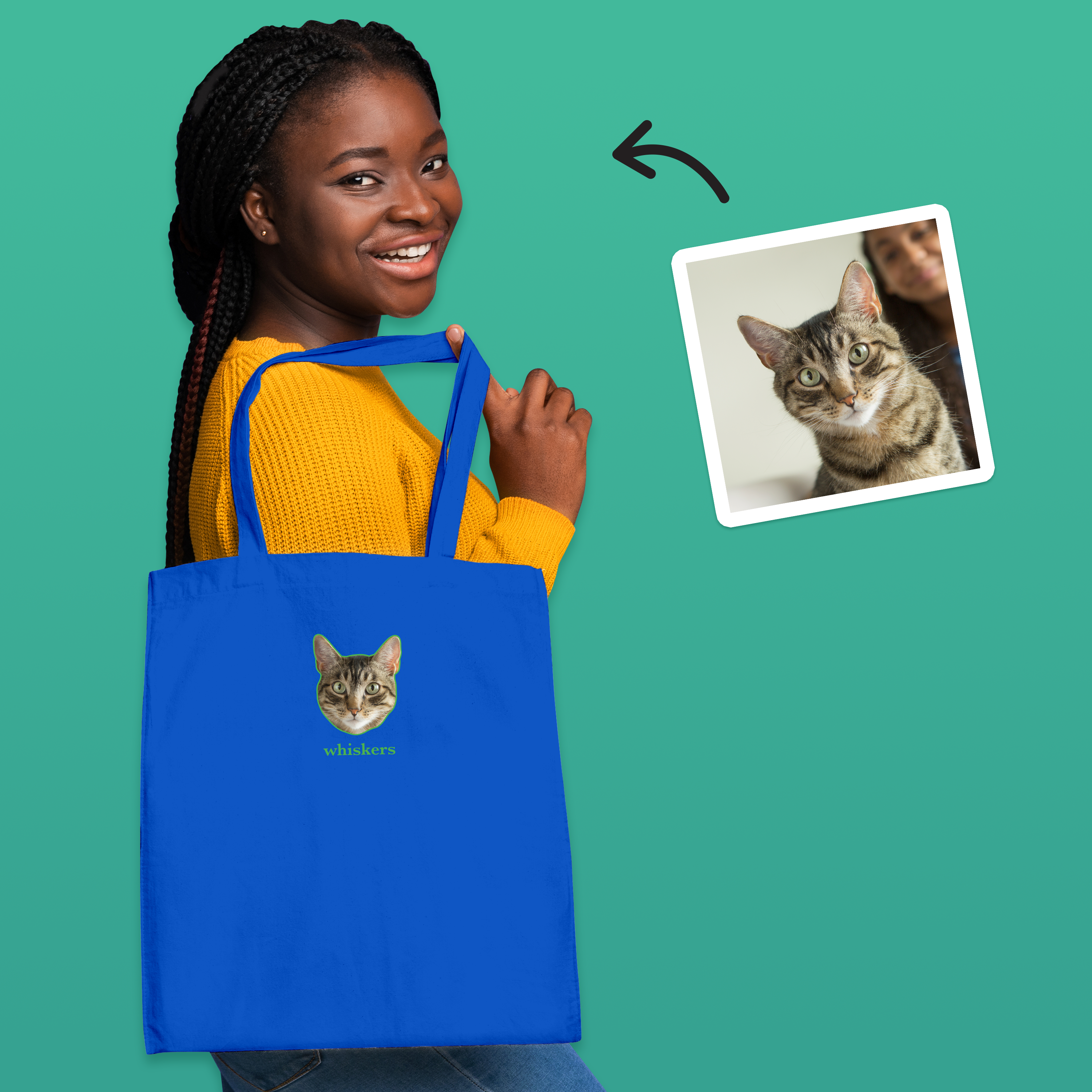 A female model modelling a blue tote bag that can be customised with the face of a pet and up to two lines of custom text, it has a dog on it and reads teddys mum underneath it