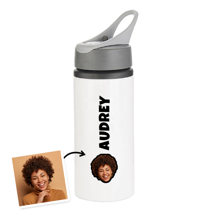 A white custom drinks bottle in a classic water bottle style that has been personalised with the name Audrey and a custom face photo of a woman at the bottom of the bottle