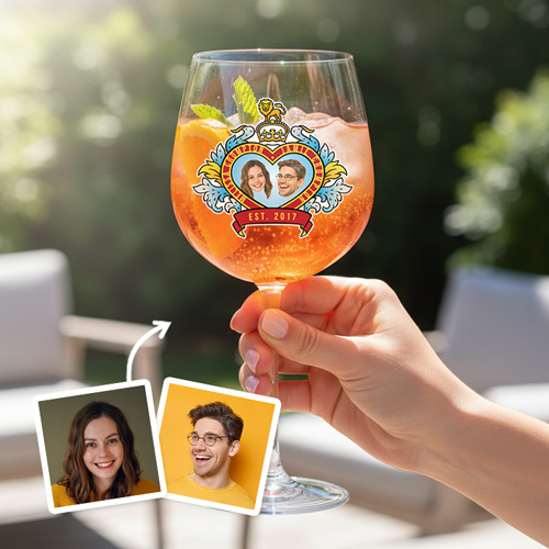A custom glass boasting a Royal Wedding style love heart design which has been personalised with a picture of a couple alongside their names and date they got married/together with a garden background