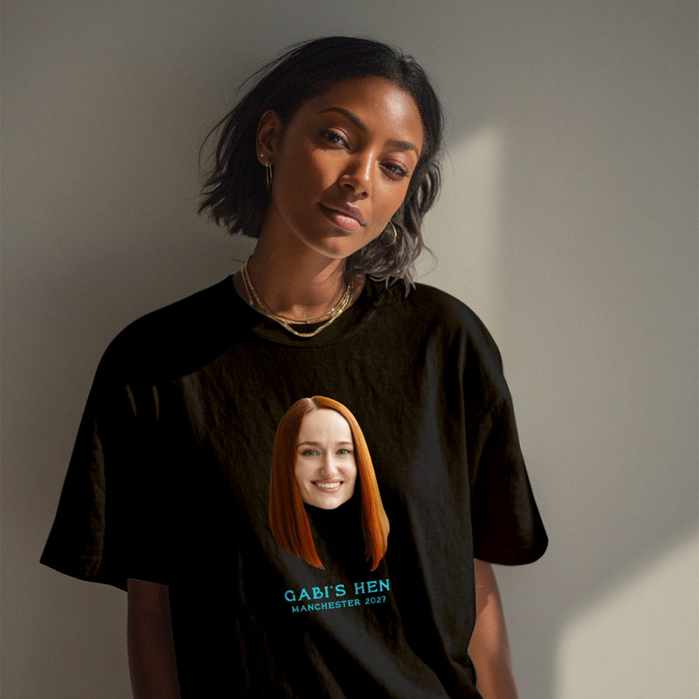 A female model wearing a custom hen do t-shirt that has been customised with a picture of a woman's face and the custom text Gabi's Hen Manchester 2027