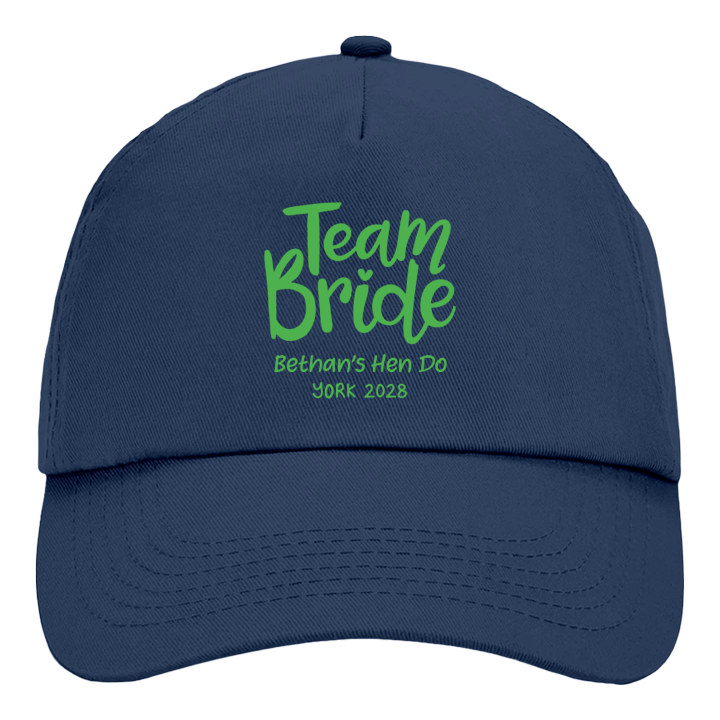 A French navy coloured custom hen do cap reading Team Bride Bethan's Hen Do York 2028 in a green font