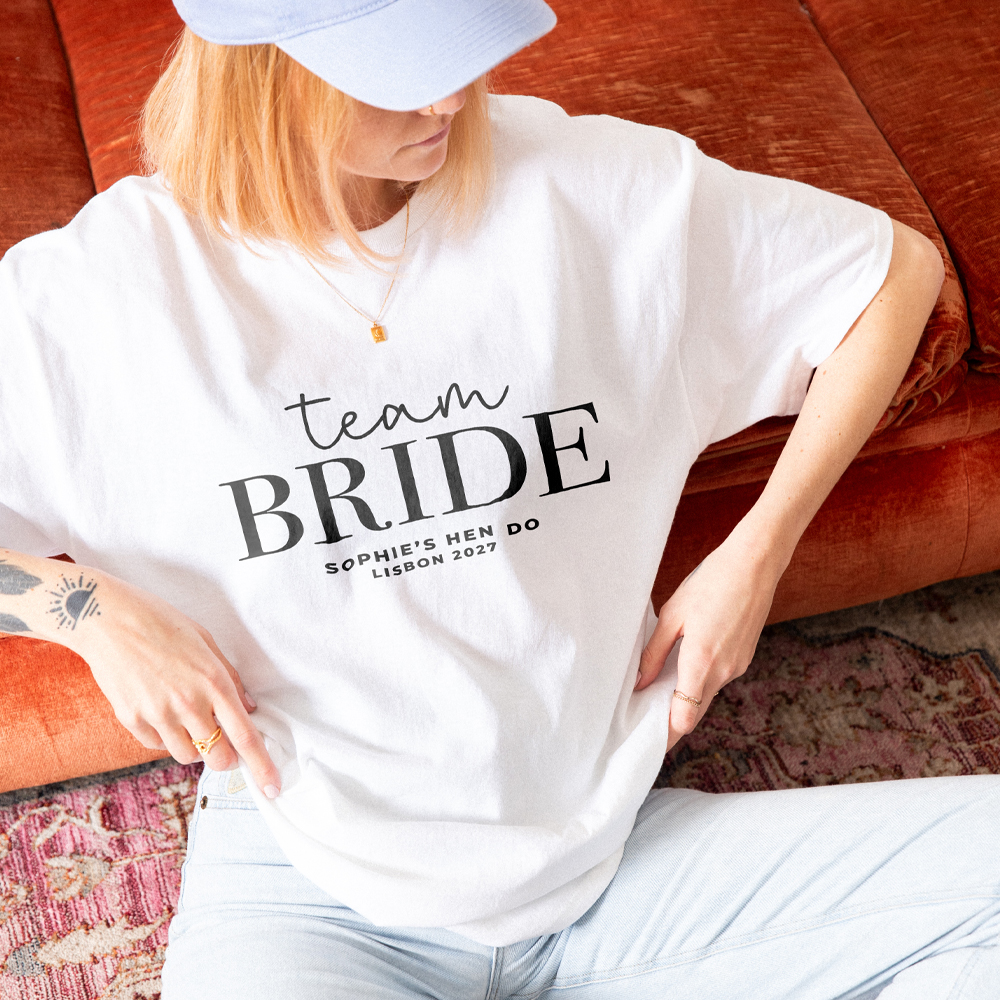 Three dark blue custom hen do t shirts that read Team Bride, Joanna's Hen Do, Newcastle 2026