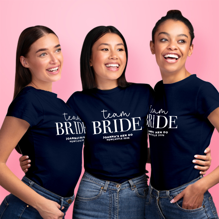 Three women wearing dark blue custom hen do t shirts that read Team Bride, Joanna's Hen Do, Newcastle 2026