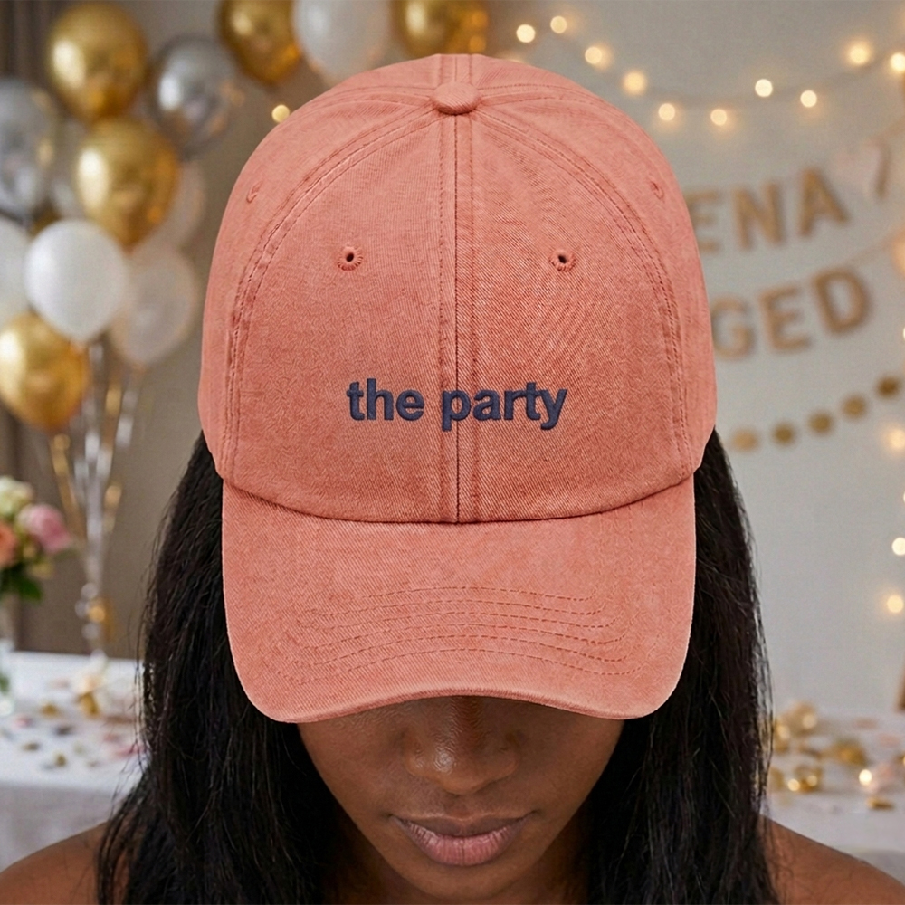 A female model with a hen do party blurred background wearing a premium hen do cap in vintage orange with the text the party embroidered on it