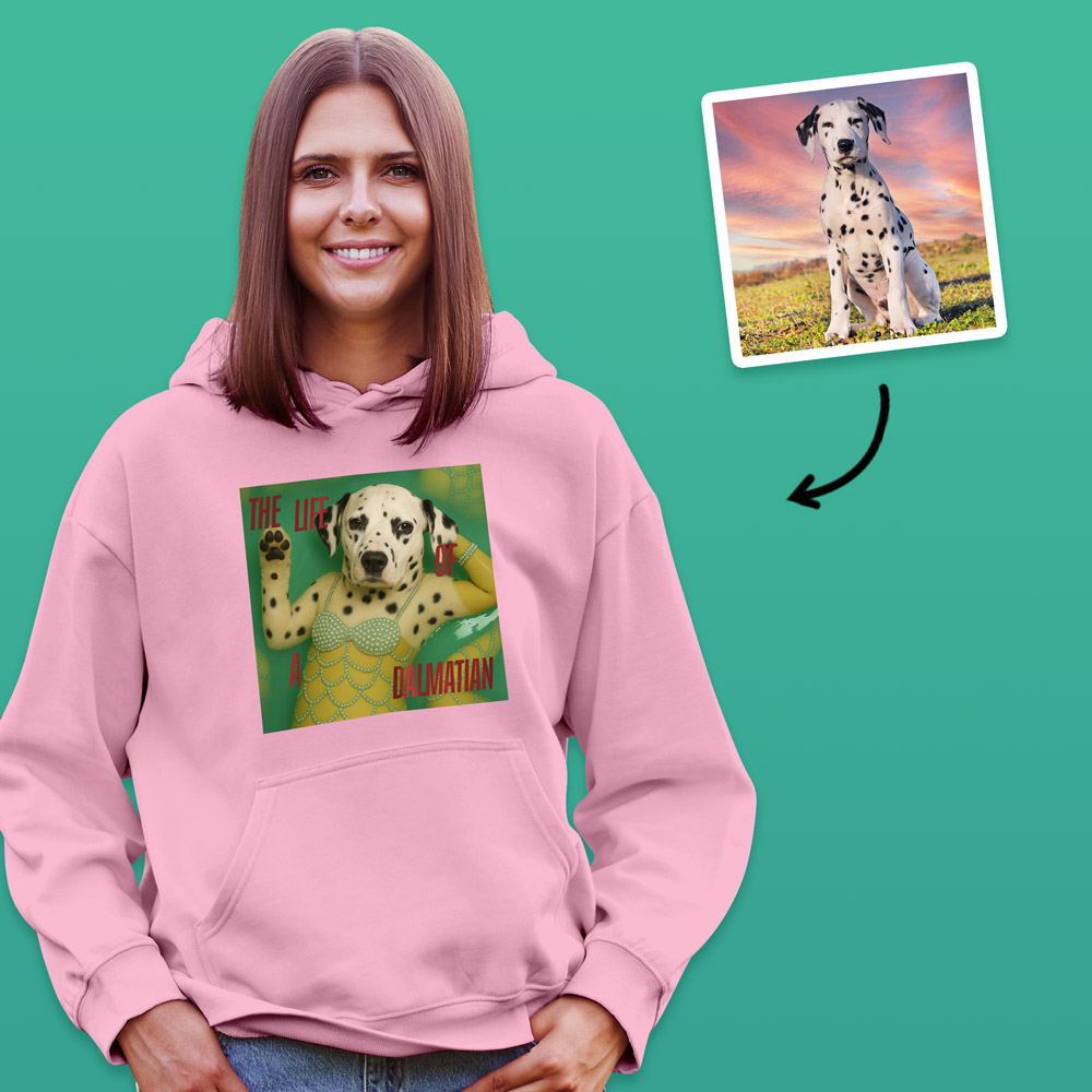 A female model wearing aTaylor Swift inspired hoodie that can have a photo of your pet added to it so it looks like they are a part of the Life of a Showgirl album, which has a dog on it with the text the life of a dalmatian