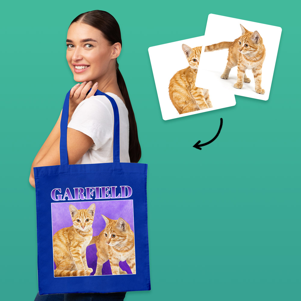 A female model wearing a custom pet tote bag with a bootleg-style design that has the same ginger cat on it twice with custom text reading Garfield