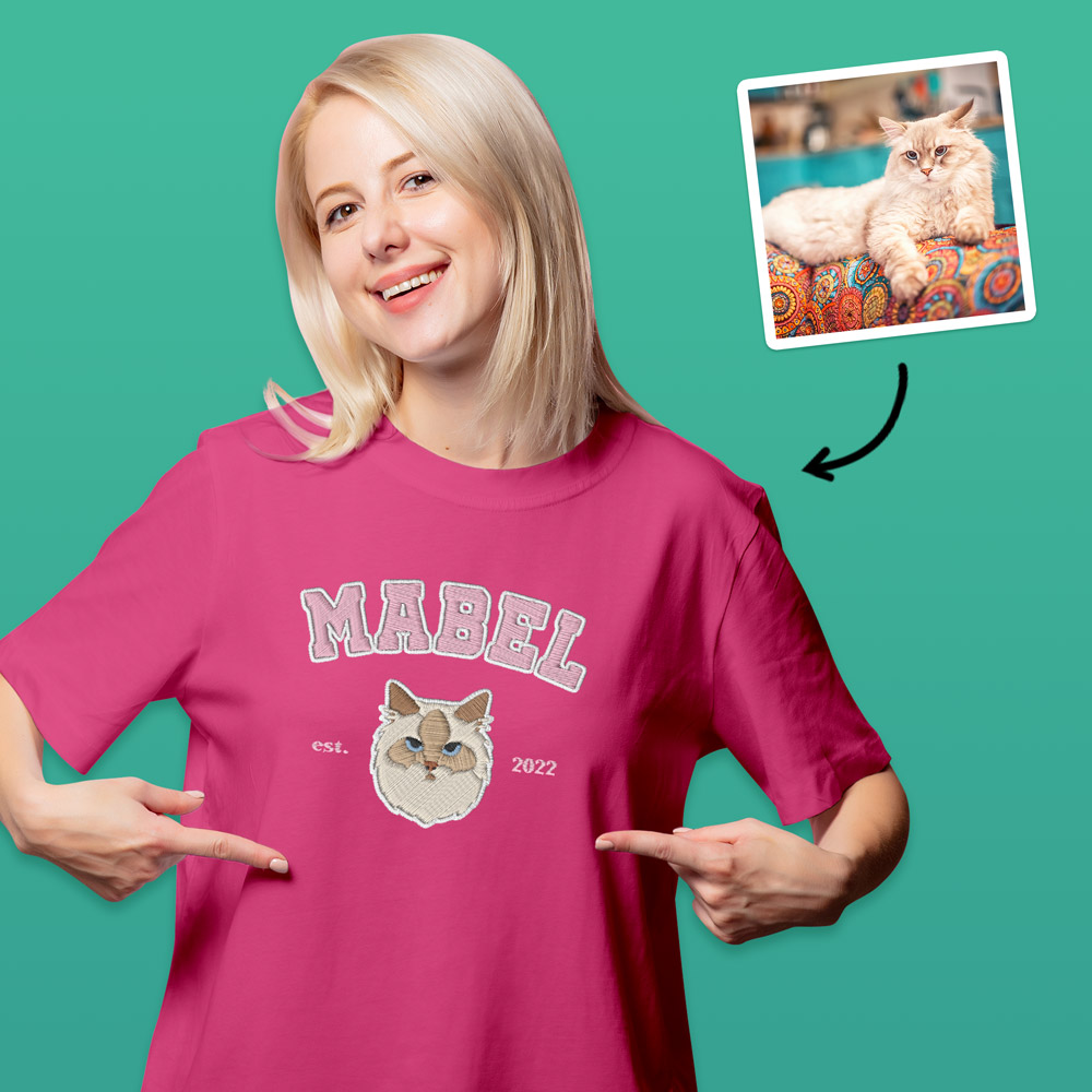 A custom pet t shirt in a varsity style which has been customised with an embroidered cat and custom text reading Mabel est 2022