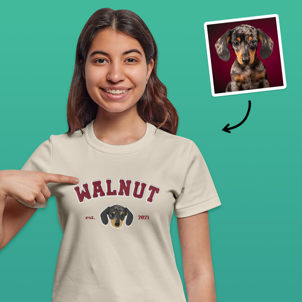 A custom pet t shirt in a varsity style which has been customised with an embroidered beagle and custom text reading Peanut est 2021 