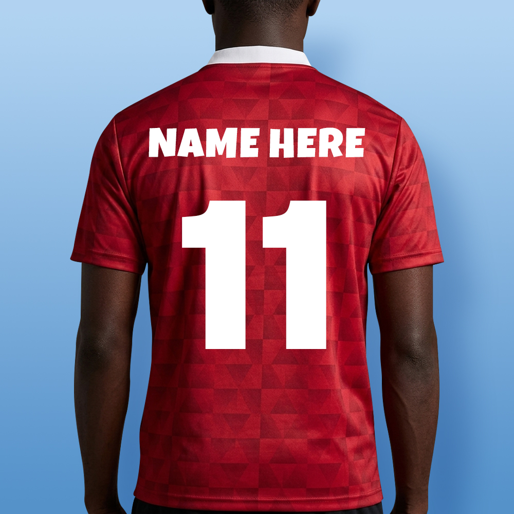 A male model wearing a custom stag do retro footie top with custom text reading Jamie's Stag Manchester 2027 which has been personalised with a face photo of the stag