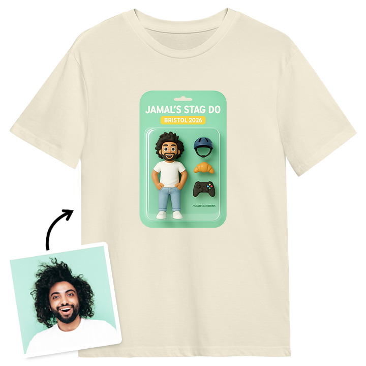 A white stag do t shirt reading Jamal's Stag Do Bristol 2025, with an AI generated packaged action figure toy that can be customised to look like the stag by editing his outfit and adding three accessories. The accessories for this one are a bike helmet, a croissant and a video game controller