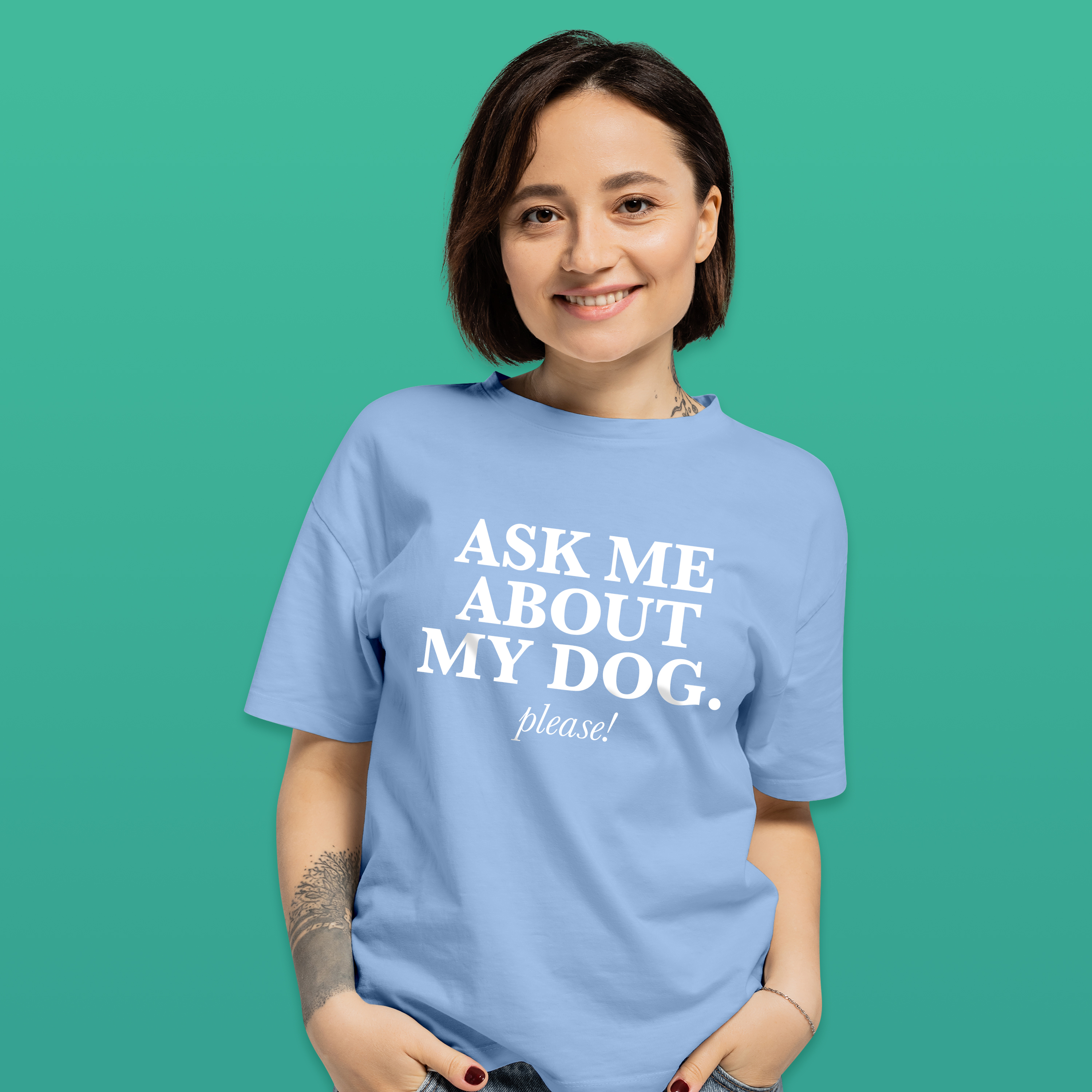 A female model wearing a light blue pet t shirt with white writing that reads 