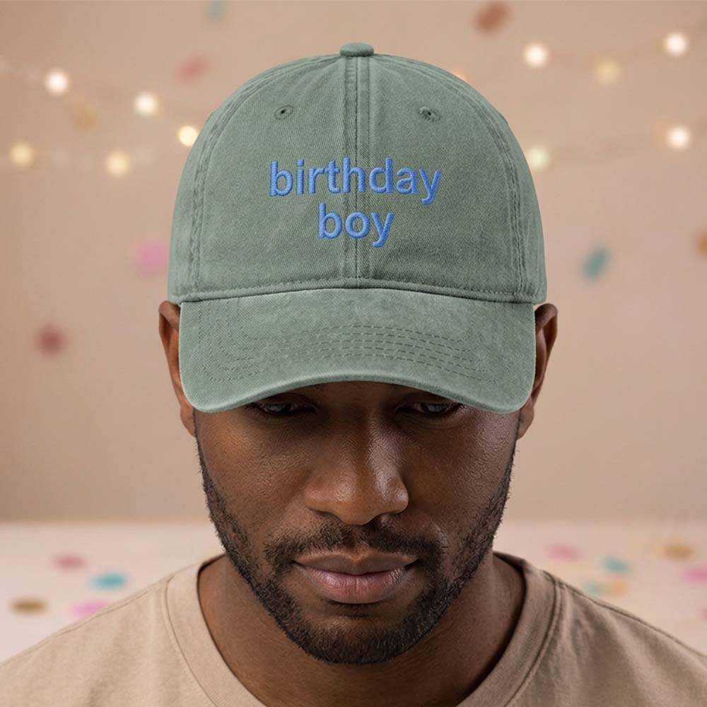 A female model wearing a premium hen do cap in green that has been embroidered with the phrase bikinis and martinis in a darker green font