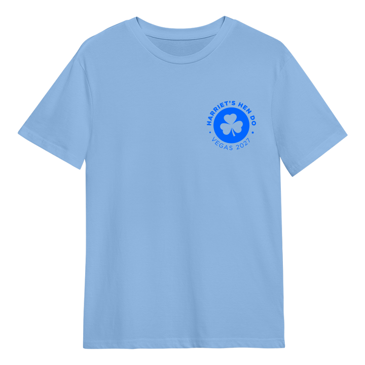 A custom hen do t shirt that has a subtle emblem in the top right hand corner of a shamrock with the custom text Harriet's Hen Do Vegas 2027 around it 