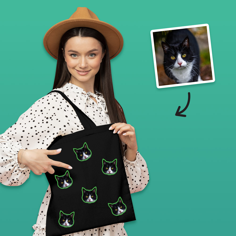 A custom pet tote bag that has space for multiple faces of your pet all over the bag, this one has black and white cats on it