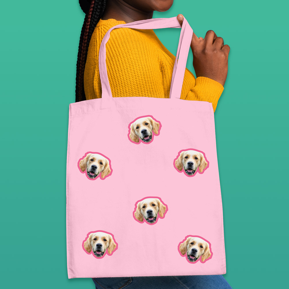 A custom pet tote bag that has space for multiple faces of your pet all over the bag, this one has Labradors on it 