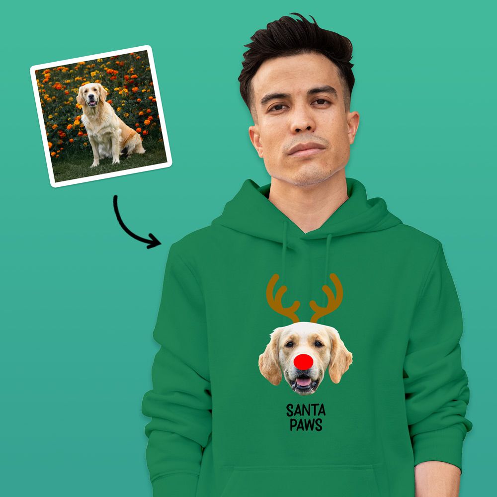 -A custom pet hoodie that has been personalised with a dog's face wearing antlers and a red nose like Rudolph alongside custom text reading Santa Paws
