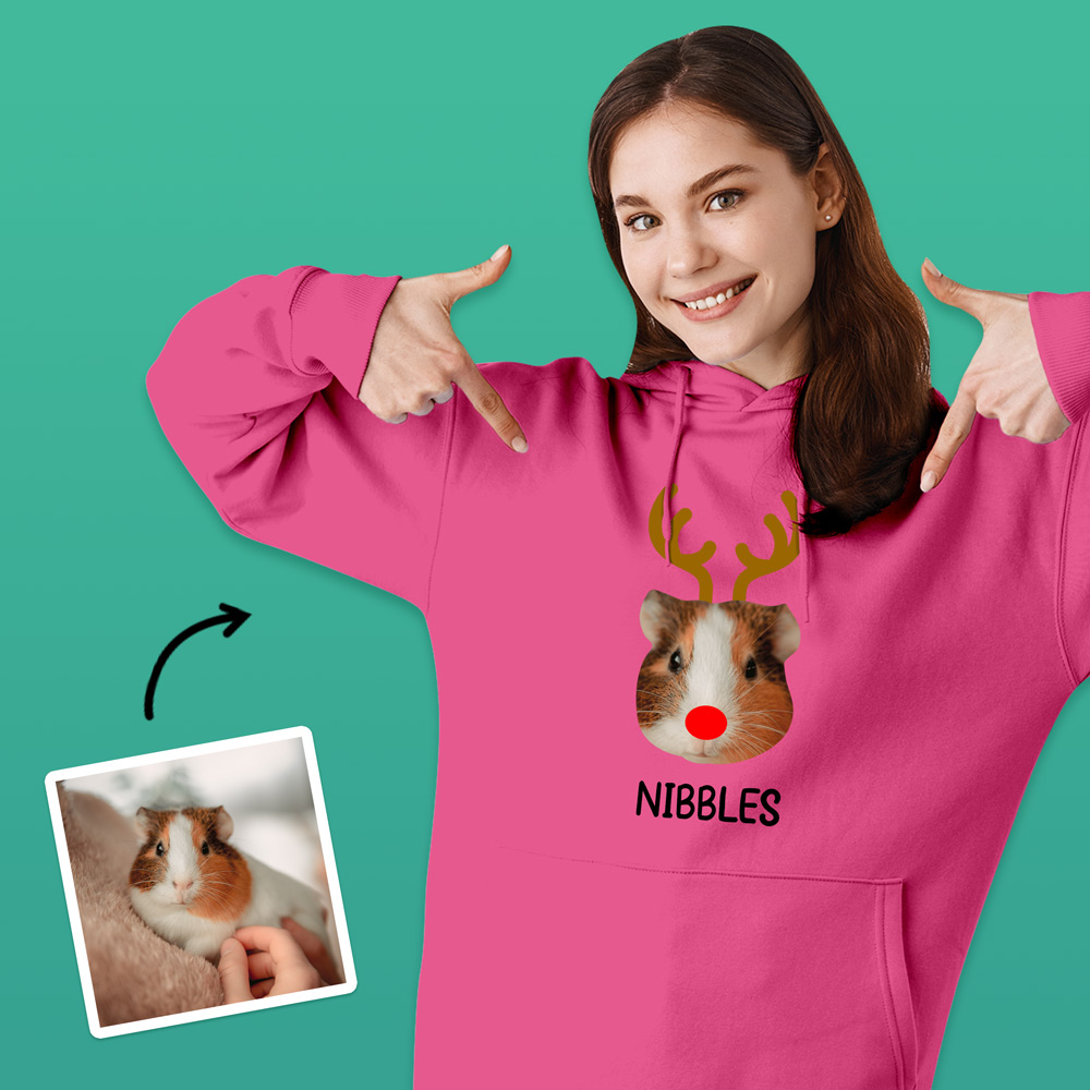 A custom pet hoodie that has been personalised with a guinea pig face wearing antlers and a red nose like Rudolph alongside custom text reading Nibbles
