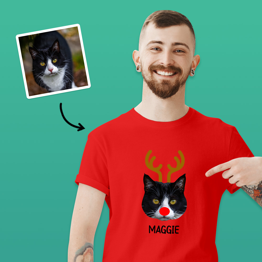 A custom pet t-shirt that has been personalised with a cat's face wearing antlers and a red nose like Rudolph alongside custom text reading Maggie