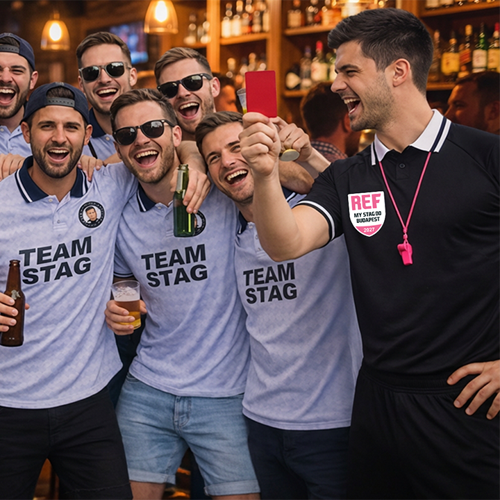 A stag do group wearing team stag footie tops with the stag who is wearing a black ref footie top and giving the lads the red card
