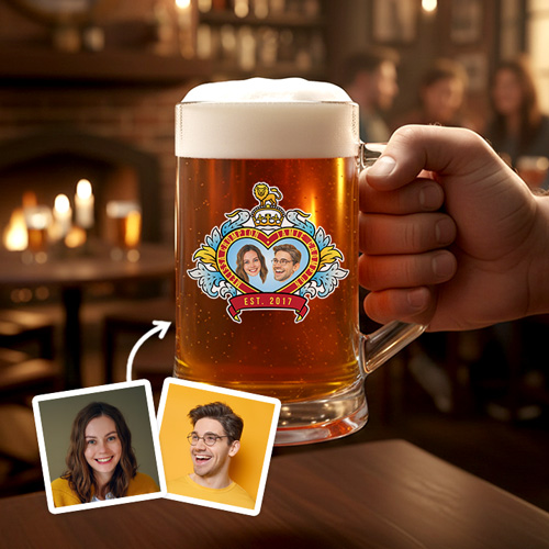 A custom stein boasting a Royal Wedding style love heart design which has been personalised with a picture of a couple alongside their names and date they got married/together with a pub background 