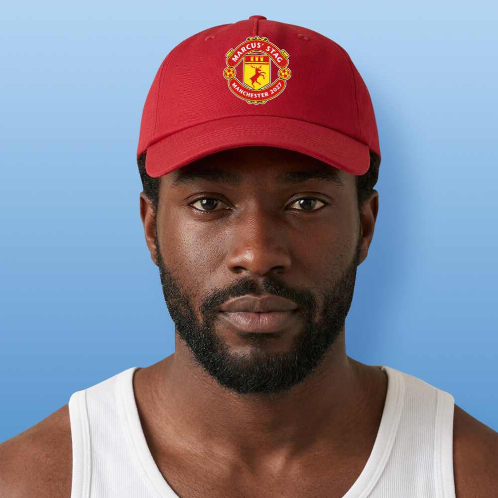 A male model wearing a red Manchester-United inspired custom stag do cap with the Man U logo that is a stag with custom text reading Marcus' Stag Manchester 2027