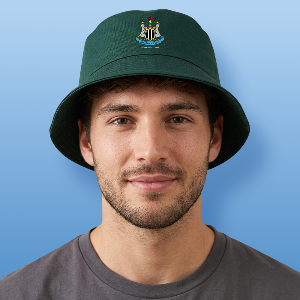 A male model wearing a green custom Newcastle United stag-themed bucket hat which has the Newcastle United logo with two stags and custom text reading Jonathan's Stag Newcastle 2027