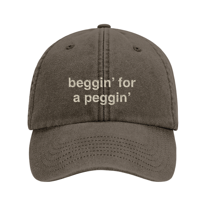 A rude premium vintage cap in brown that has been embroidered with beggin for a peggin in tusk coloured thread 
