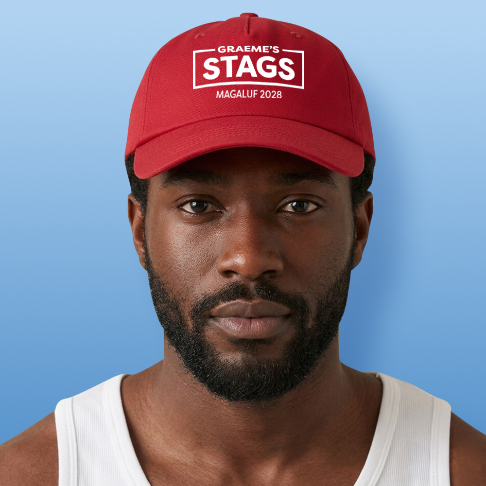A male model wearing a red custom stag do cap that reads Graeme's Stags which is in the middle of a rectangular box with Magaluf 2028 below it