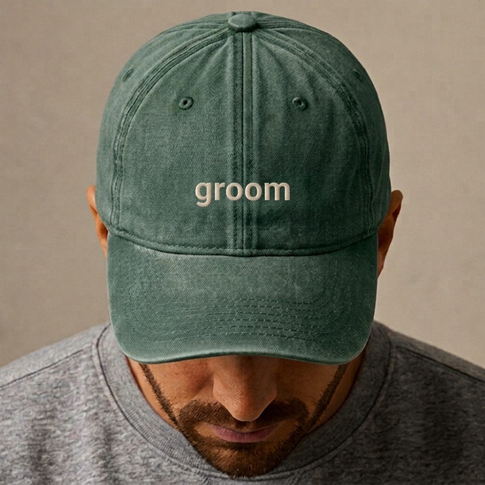 A male model wearing a premium custom stag do cap in bottle green that has been embroidered with groom in tusk text