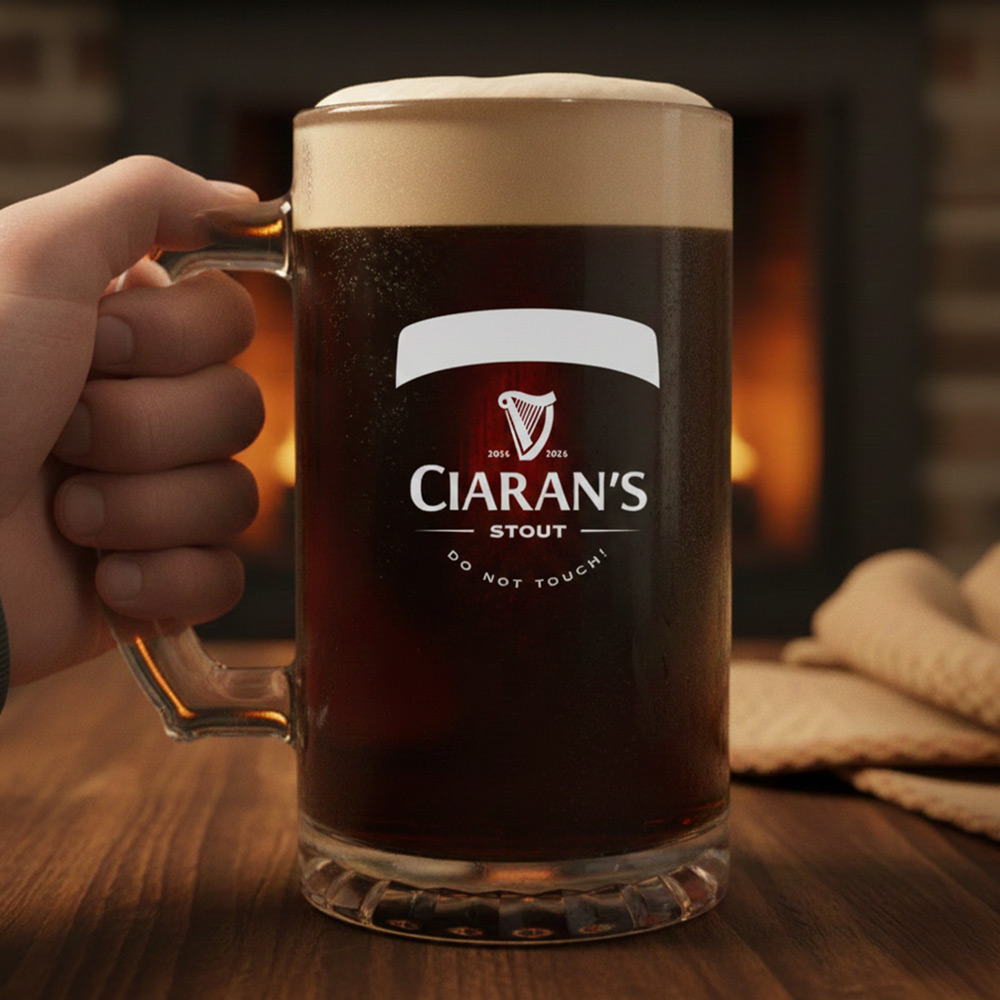A custom Guinness themed stein that has the custom text Ciaran's Stout Do Not Touch which is full of Guinness and has a background of a cosy fire 