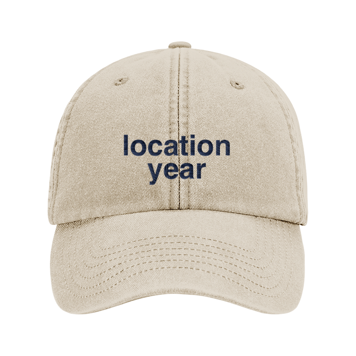 A custom text premium vintage cap in khaki that has been embroidered with 'location year' to show that the text is editable 