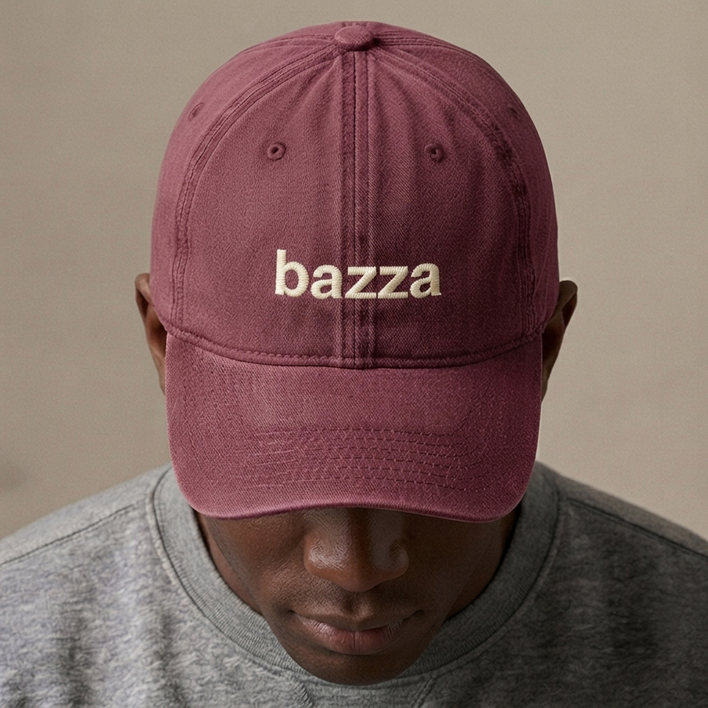 A male model wearing a custom text premium vintage cap in red that has been embroidered with the nickname bazza