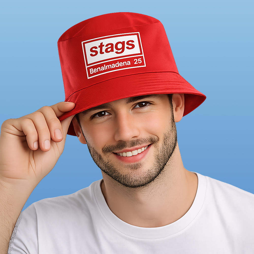 A male model wearing a red coloured Oasis style custom bucket hat that reads stags benalmadena '27 in the style of the Oasis logo