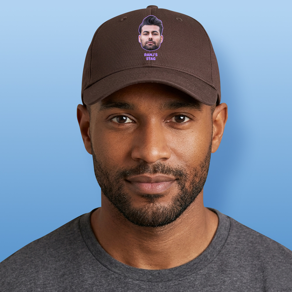 A male model wearing a custom brown cap that has been personalised with a man's face and custom text reading Ranj's Stag