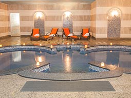 A spa room with a swimming pool