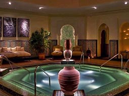 The interior of a spa with a lit up swimming pool