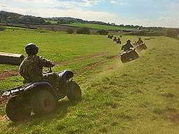 People driving quad bikes into the distance