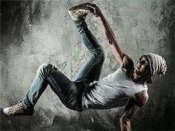 A man in a beanie hat doing a dance move