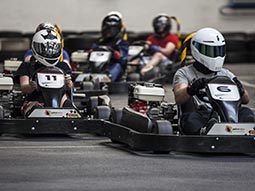 A group of people driving go-karts