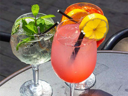 An orange coloured cocktail sitting on a table