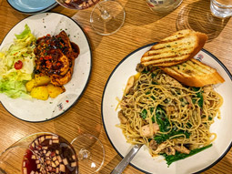 A salad and prawn linguine dish with garlic bread and a glass of Sangria as part of a 3 course meal in Madrid